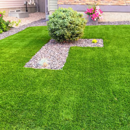 low maintenance lawn idea for property managers who want to save money on landscaping using artificial grass